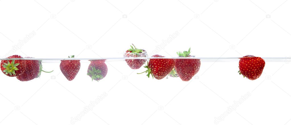Strawberries in water on an isolated background