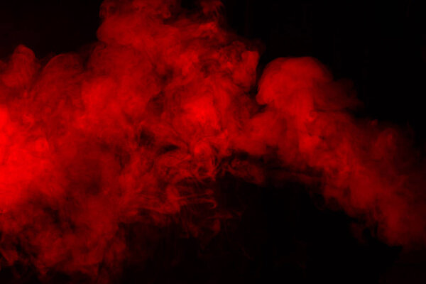 Red smoke or steam on a black background.