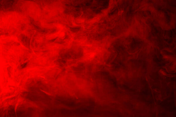Red smoke on a black background, abstract background
