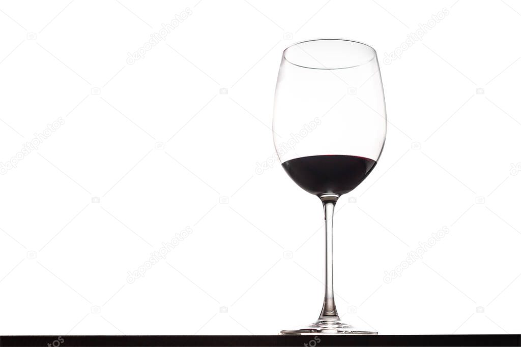 Glass of red wine on table with isolated background