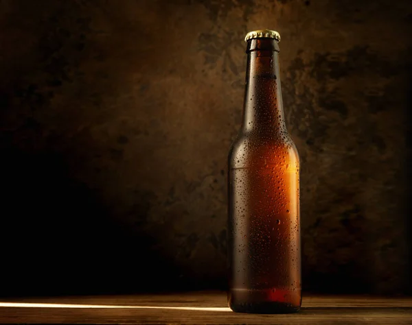 Beer bottle on dark background