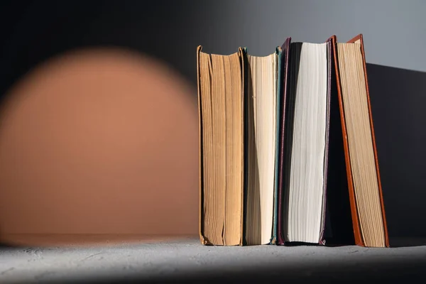 Books on a shelf with a bright orange light spot