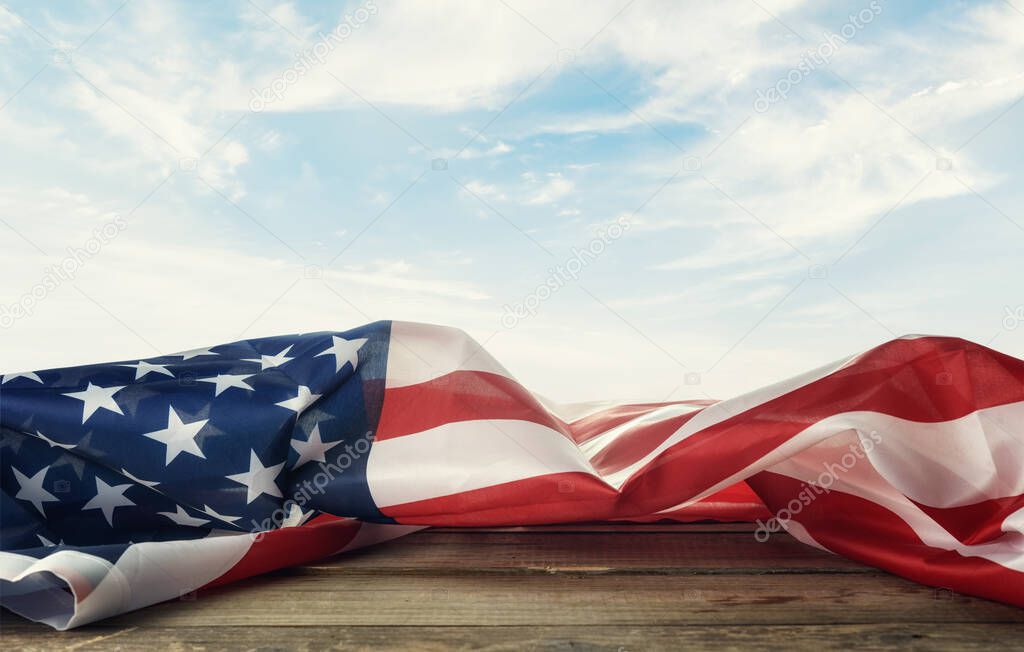 USA  flag on the table against the background of the sky.