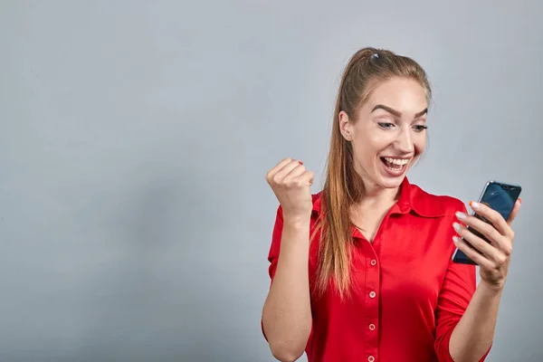 Girl brunette in red blouses over isolated white background shows emotions — Stock Photo, Image