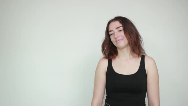 Izole beyaz arka plan üzerinde siyah tank üst güzel kız duyguları gösterir — Stok video
