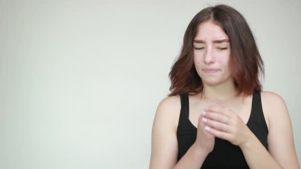 Beautiful girl in black tank top over isolated white background shows emotions — Stock Video