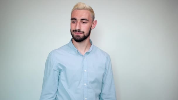 Uomo con i capelli biondi, barba nera su sfondo bianco isolato mostra emozioni — Video Stock