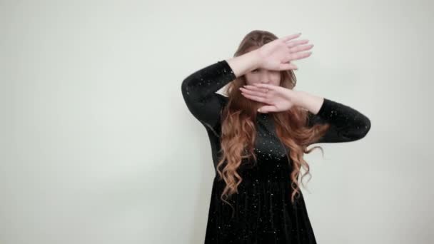 Κορίτσι καστανά μαλλιά με μαύρο φόρεμα πάνω από απομονωμένο λευκό φόντο δείχνει τα συναισθήματα — Αρχείο Βίντεο
