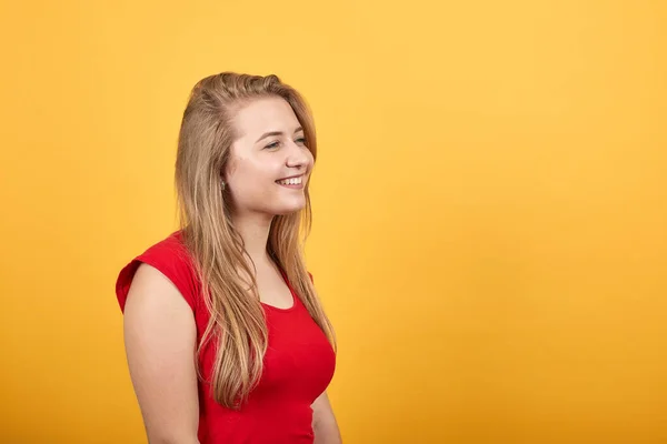 Νεαρή ξανθιά κορίτσι με κόκκινο μπλουζάκι πάνω από απομονωμένο πορτοκαλί φόντο δείχνει τα συναισθήματα — Φωτογραφία Αρχείου