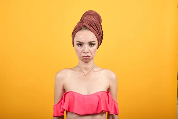 Chica joven con toalla en la cabeza sobre fondo naranja aislado muestra emociones —  Fotos de Stock