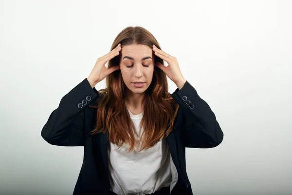 Headache grimacing pain holds the back of her neck indicating location. Fatigue