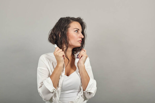 Teen smiling model brushing hand through hair, fashion posing, hands in strand