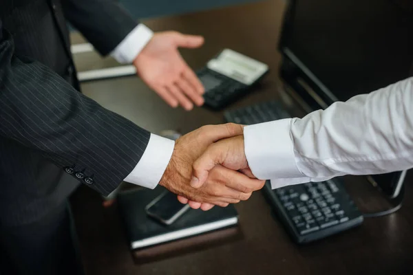 Close-up of the partners ' handshake, completion of the transaction in the office. Business