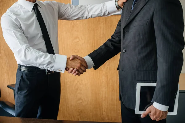 Handshake of partners, completion of the transaction in the office. Business