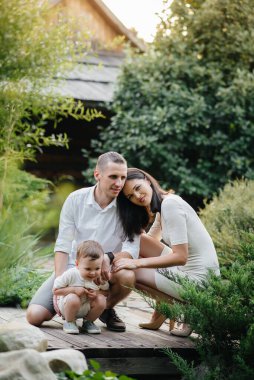 Oğulları gün batımında parkta yürüyen mutlu bir aile. Mutluluk. Aşk