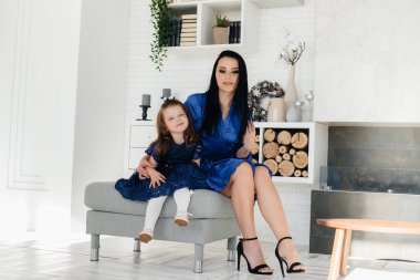 Anne ve kızları kanepede oynuyorlar. Bir aile. Mutluluk.