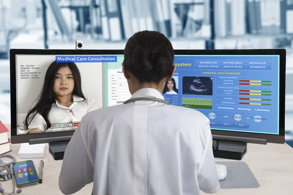 Female Doctor Working Two Computers Distance Patient Consultation Searching Her — Stock Photo, Image