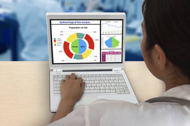 Epidemiyolojik veri analiz etmek için dizüstü bilgisayar üzerinde çalışan kadın doktor.