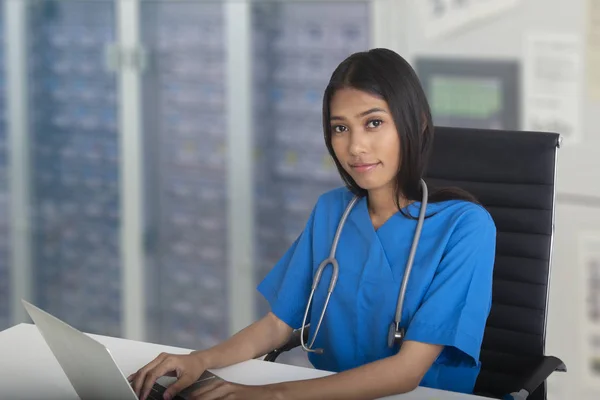 Doctora que trabaja con computadora portátil en su oficina . — Foto de Stock