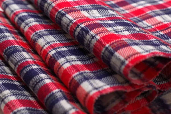 Red, blue and white tartan pattern cloth. Texture detail close up.