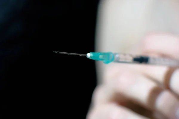 Syringe needle close up. Intravenous drugs.