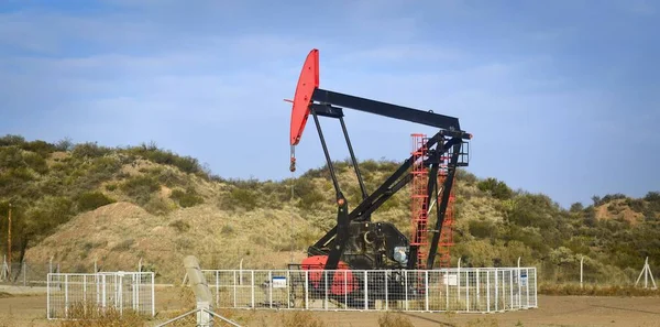 Oil extraction pumpjack in the desert of Mendoza, Argentina.