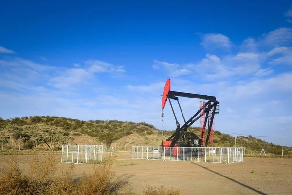 Oil extraction pumpjack in the desert of Mendoza, Argentina.