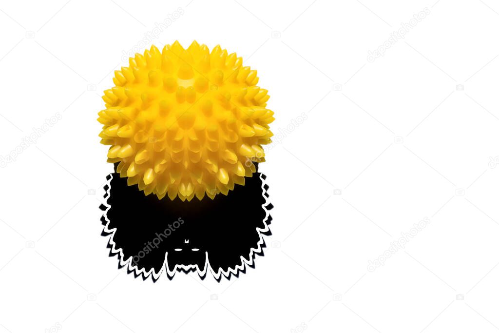 Abstract image of coronavirus. A yellow ball with spikes and its shadow in the shape of a bat are located on a white background.