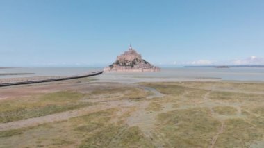 backing-up drone shot view of mont saint michel, France 2018-09-01 Mont Saint-Michel and its bay are on the UNESCO list of World Heritage Sites