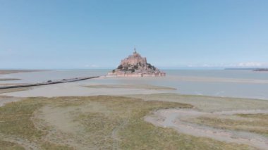 rotating aerial view of mont saint michel, France 2018-09-01 The structural composition of the town exemplifies the feudal society that constructed it: on top, God, the abbey and monastery