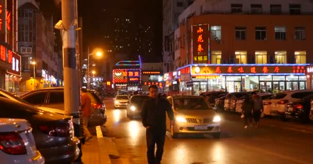 Люди ходят по дороге осенней ночью. традиционные китайские чувства с окружающими ресторанами. Далянь, Китай — стоковое видео