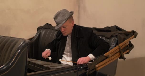 Mann spielt Glockenspiel in altem Auto — Stockvideo