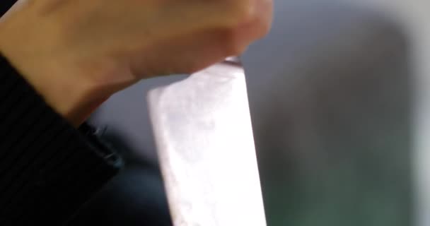 Big kitchen knife cutting into pumpkin, this beautiful woman is making a carved pumpkin that will become a Jack O Lantern, for trick or treat celebration game — Stock Video