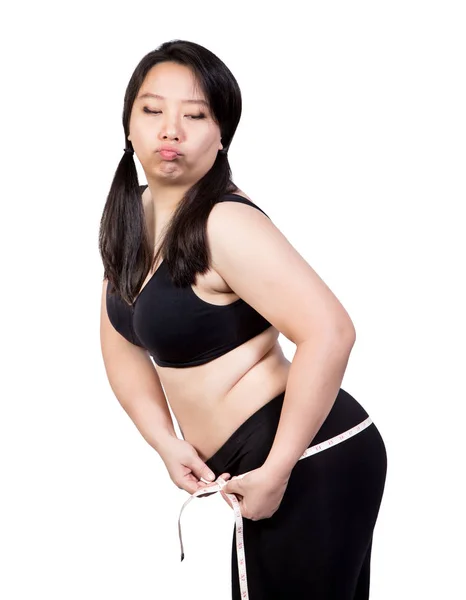 Fet kvinna visar övervikt kropp tight feta genom att mäta tejp på höft uttråkad ansikte viktminskning konceptet isolerade på vit bakgrund — Stockfoto