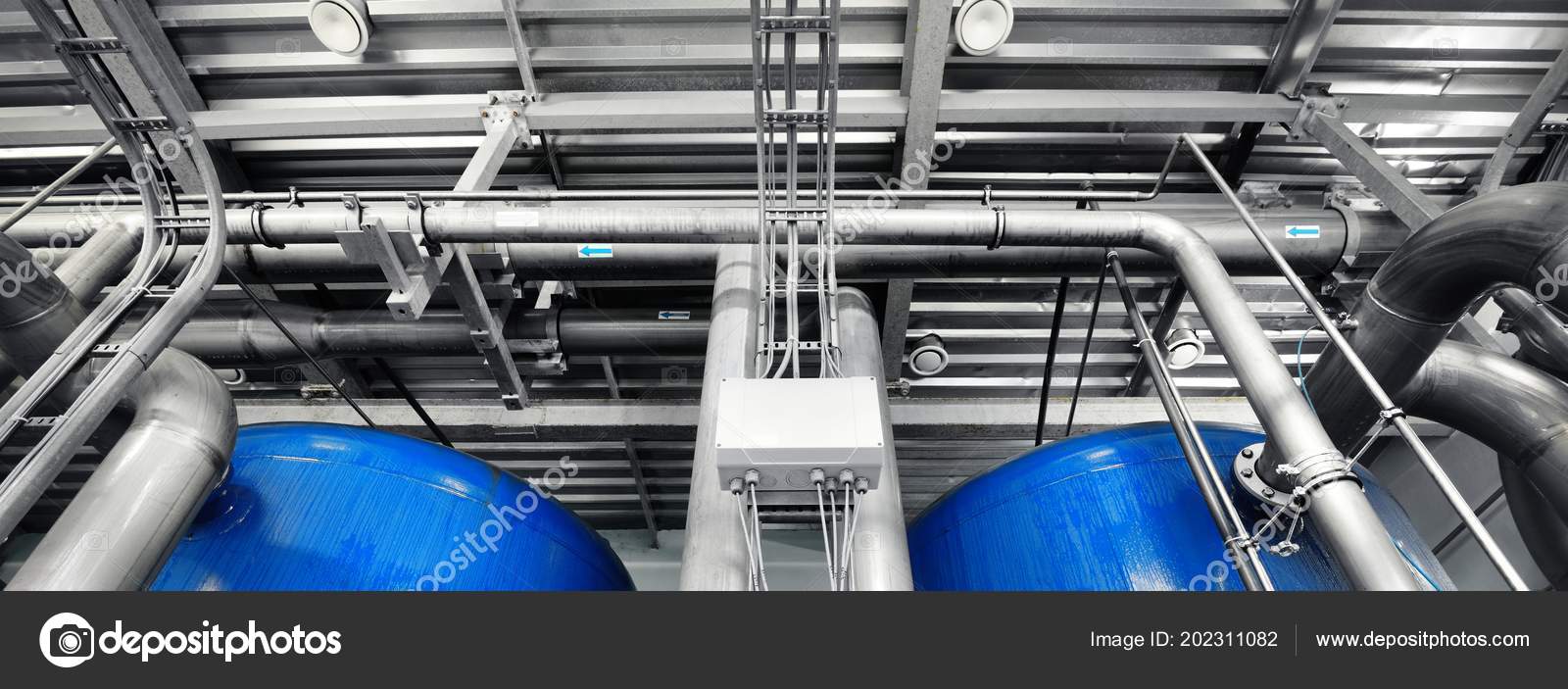 Large Industrial Water Treatment Boiler Room Shiny Steel Metal Pipes