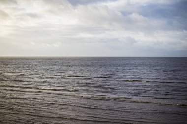 Güneş ışınları ve bulutlar. Baltık Denizi üzerinde renkli gökyüzü