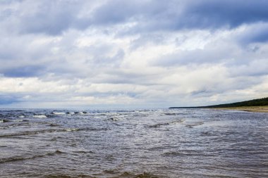 Bulutlu bir mavi fırtınalı havada, Letonya Baltık denizin dalgaları