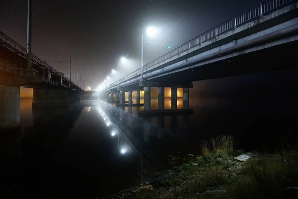 A view of the two bridges in the port with lights at night