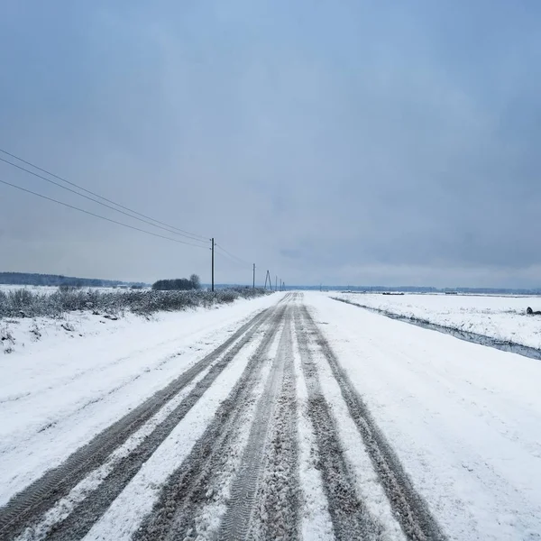 未铺砌的乡间小路在白雪皑皑的冬日 — 图库照片