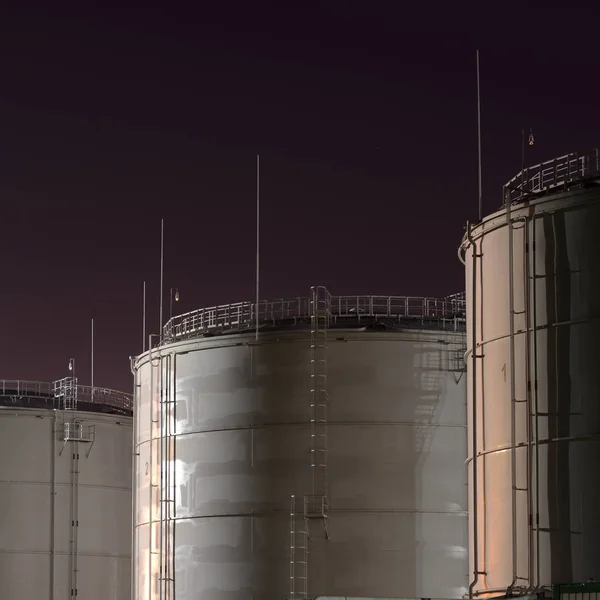 Fuel tanks in port at night time