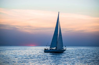 Gün batımında beyaz yat yelkenleri, Baltık denizi, Letonya