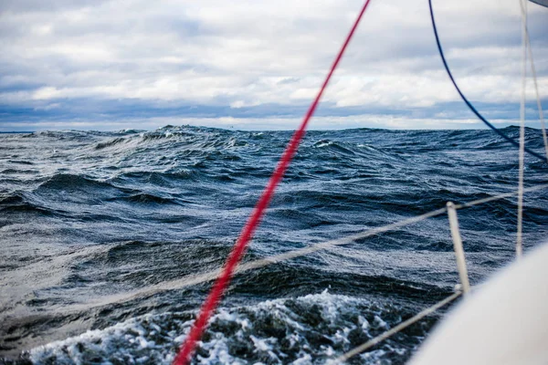 Winter sailing. A view from the yacht's deck to the bow. Baltic sea, Latvia