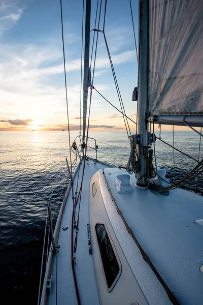 Sailing at sunset. A view from the yacht\'s deck to the bow and sails, Baltic sea, Latvia