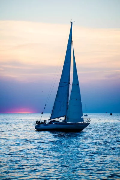 White yacht sails at sunset, Baltic sea, Latvia