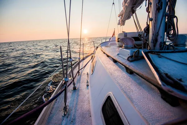 Sailing at sunset. A view from the yacht's deck to the bow. Baltic sea, Estonia