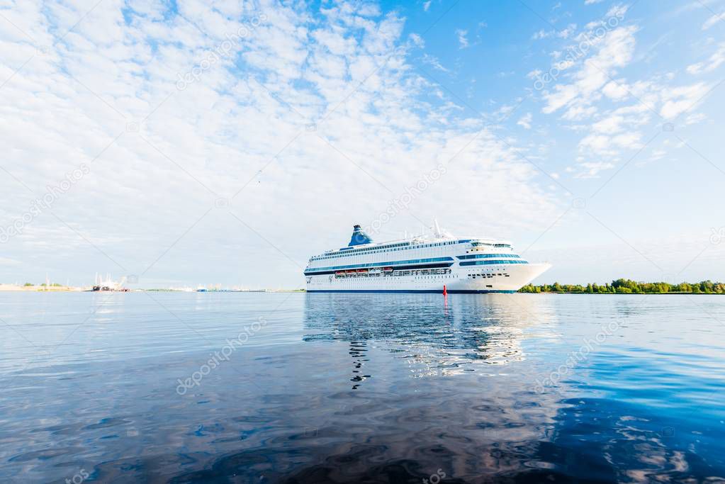 Summer sunset. Large white passenger ship and a pilot boat in the Baltic Sea, close-up. Latvia