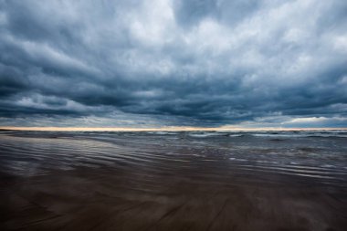 Fırtınalı hava. Bulutlu bir sonbahar gününde Baltık denizi ve deniz kıyısı manzarası, Letonya