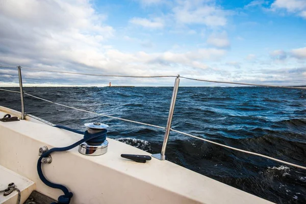 Winter sailing. A view from the yacht\'s deck to the bow. Baltic sea, Latvia