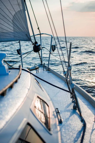 Sailing at sunset. A view from the yacht\'s deck to the bow and sails. Close-up. Baltic sea, Latvia