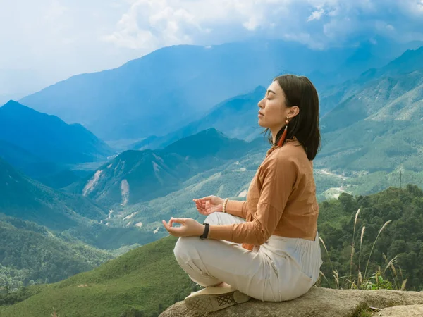 Asian woman meditation at the mountain